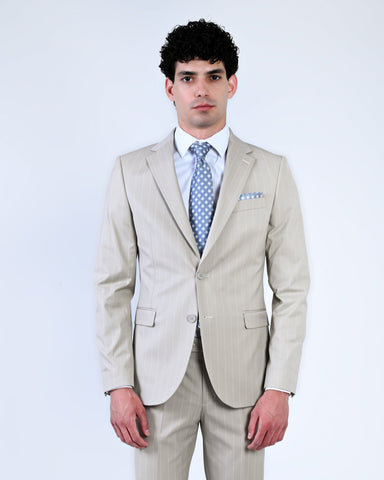 Man wearing a beige suit with a blue tie 